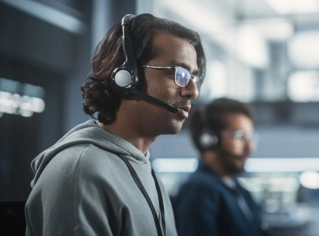 Contact center agents wearing headsets during customer conversations